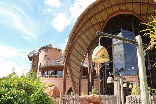 exterior of a building with a thatched roof and colorful hanging lights