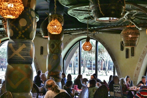 interior of a busy restaurant with hanging lights and colorful columns