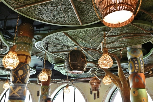 a restaurant ceiling that resembles a tree canopy with hanging lights