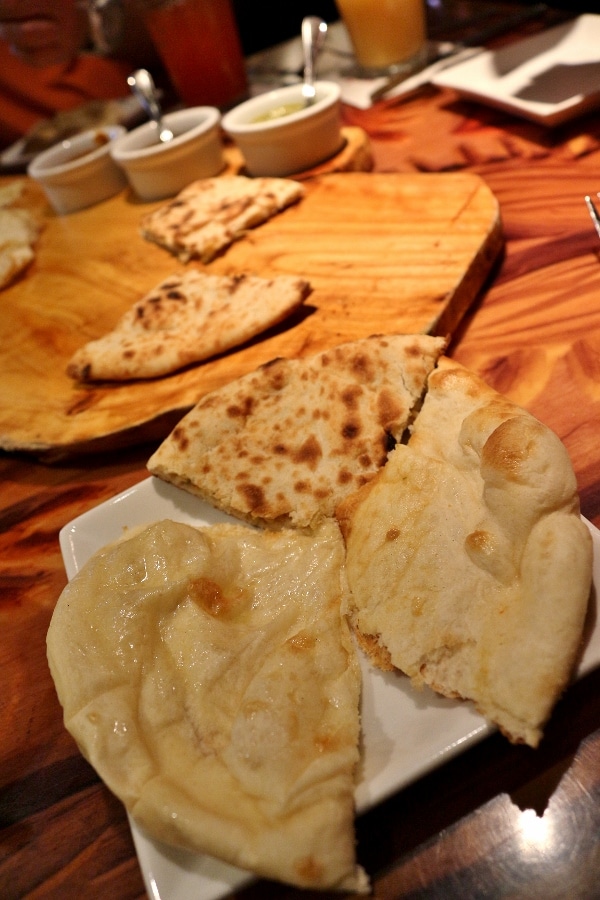 a variety of Indian and African breads served on a plate