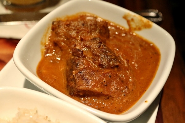 a closeup of a bowl of beef short rib in curry sauce