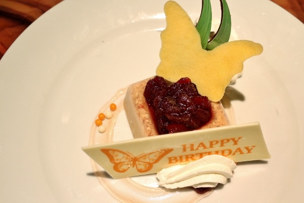 a dessert plate with a sign that says Happy Birthday