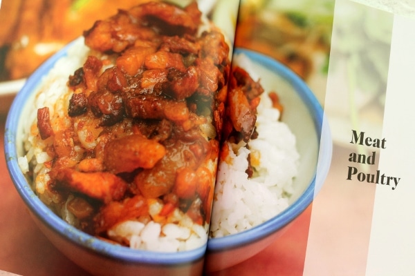 a reddish-brown colored stir-fry mixture served over white rice in a bowl