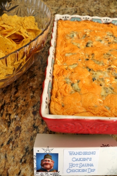 a sign that says Wandering Oaken\'s Hot Sauna Chicken Dip in front of food