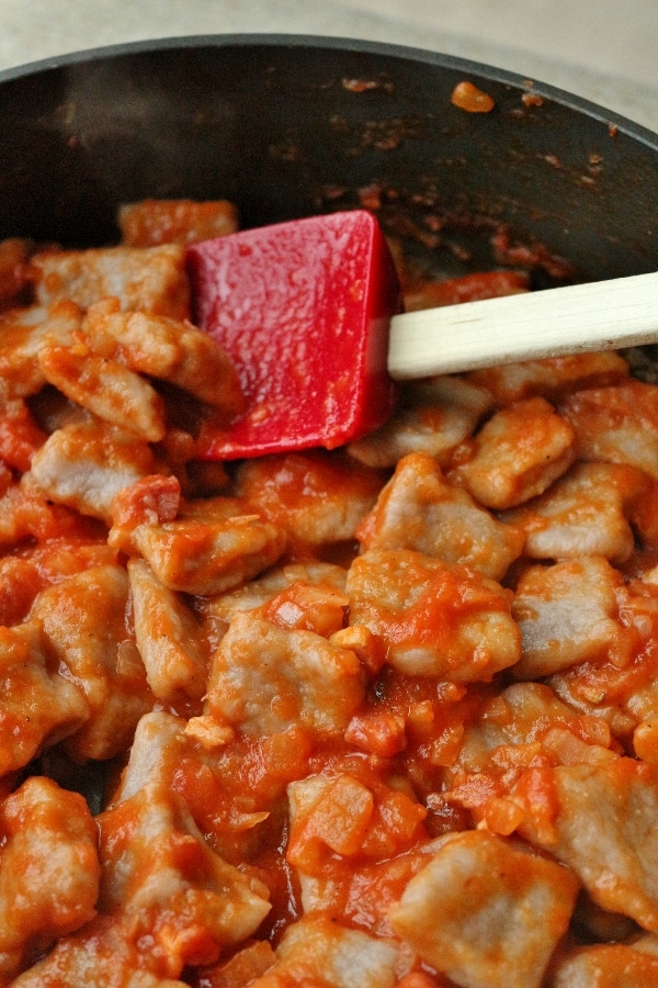 gnocchi tossed in tomato based Amatriciana sauce in a pan