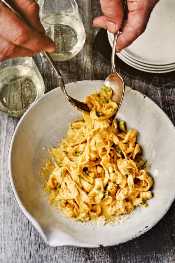 a bowl of fettuccine with a corn and scallion sauce