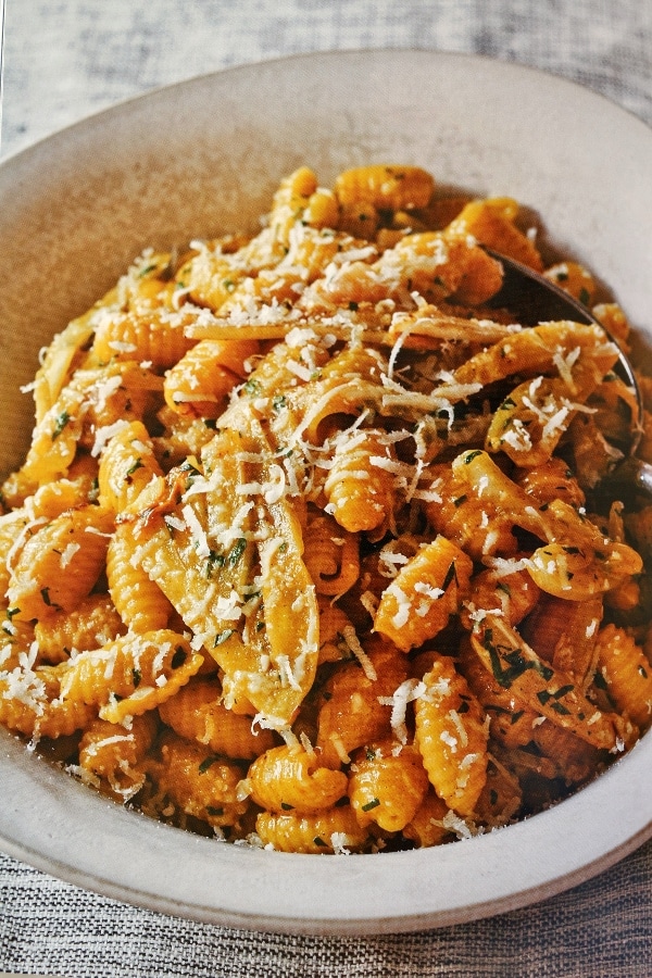 A bowl of cavatelli pasta topped with grated cheese