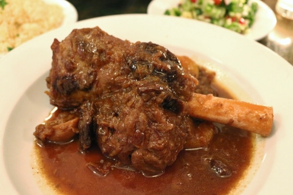 a braised lamb shank in a rich dark brown sauce
