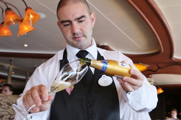 A man pouring a glass of Champagne