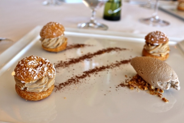 a plate of small cream puffs