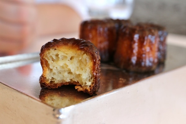 a cross-section of a cannelle pastry on a metal dish