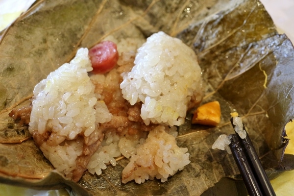 sticky rice and meat inside a large leaf