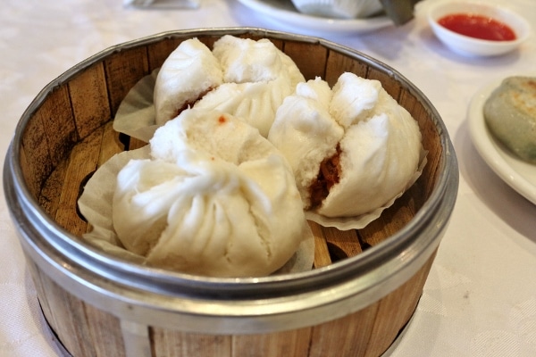 steamed Chinese buns in a bamboo steamer basket