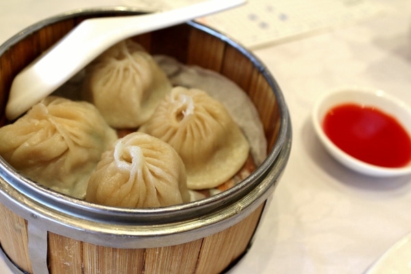 Shanghai soup dumplings in a bamboo steamer basket