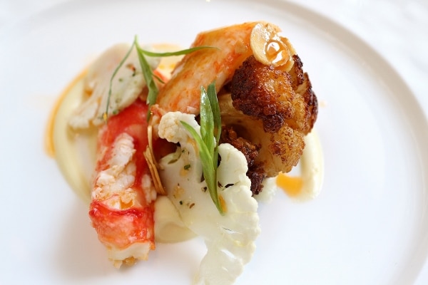 an artful plate of food featuring crab meat and cauliflower