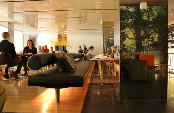 a lounge area inside a posh modern restaurant with leather seats