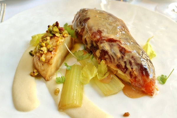 a glazed chicken breast served with pistachios and celery