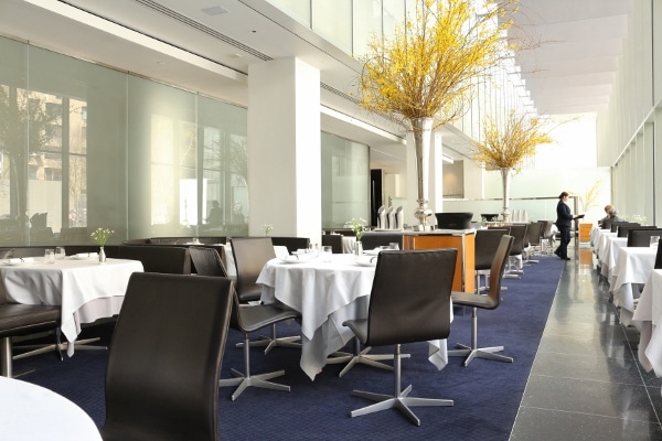 interior of a contemporary restaurant dining room with tall ceilings