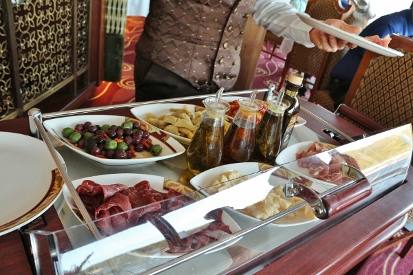 a closeup of an antipasti cart with dishes of various food items