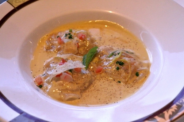 a shallow bowl of ravioli in a creamy sauce