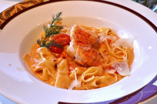 wide pasta noodles with lobster in a shallow bowl