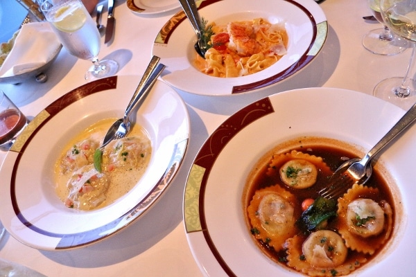 three bowls of various kinds of pasta on a table