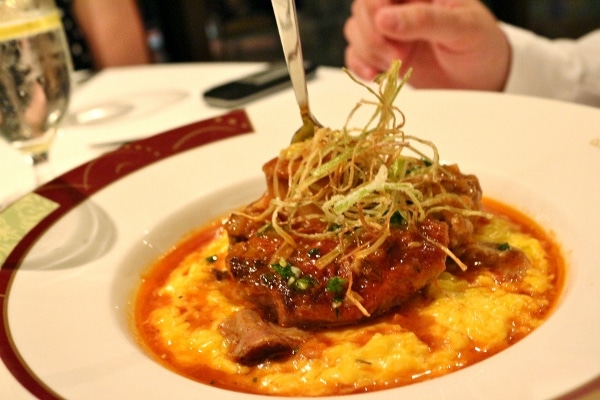 a plate of braised osso bucco served over risotto