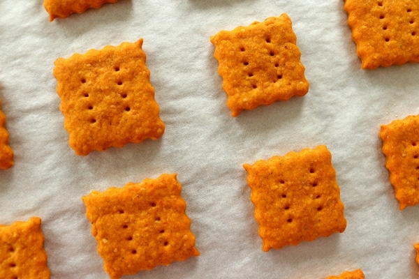 overhead closeup of homemade cheddar cheese crackers on a baking sheet