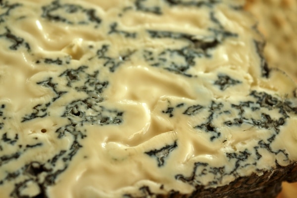 A closeup of a piece of homemade stilton blue cheese