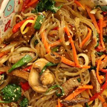 A dish of Korean sweet potato noodles with meat and vegetables (japchae)