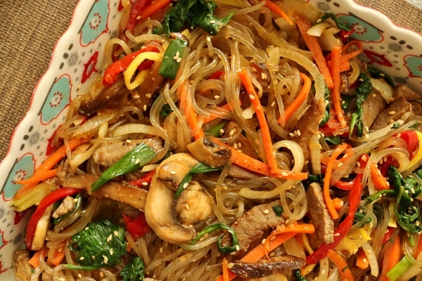 A dish of Korean sweet potato noodles with meat and vegetables (japchae)