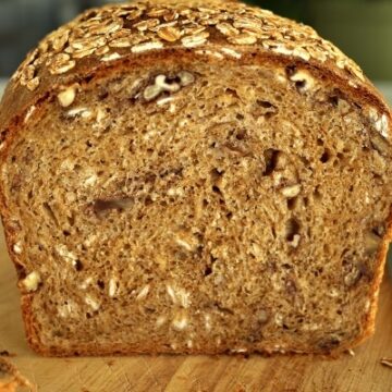 a cross-section of a loaf of whole wheat sandwich bread with oats and pecans