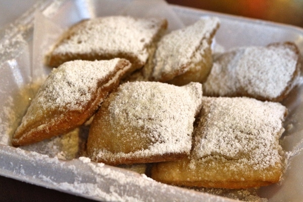 fried beignets topped with powdered sugar