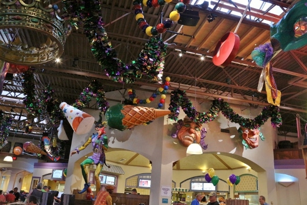 festive mardi gras style decorations hanging from a ceiling