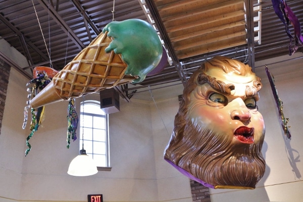 statues of an ice cream cone and a scary face hanging from a ceiling