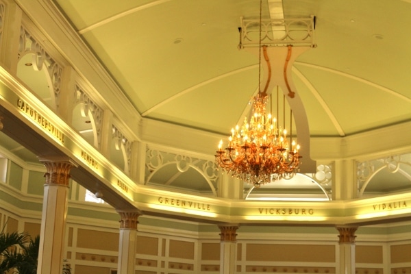 a chandelier hanging from the ceiling in a hotel lobby