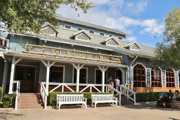 exterior of The Riverside Mill with white benches in front