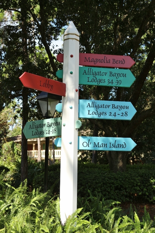 signs on a pole directing people where different buildings are