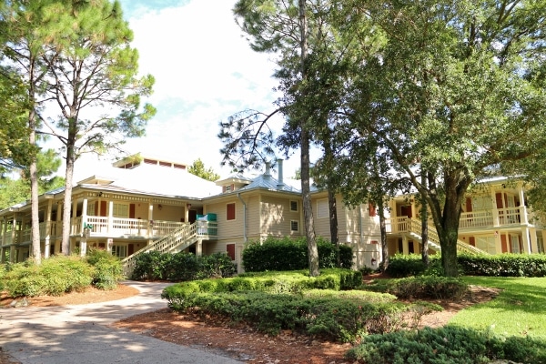 trees in front of a two-story building