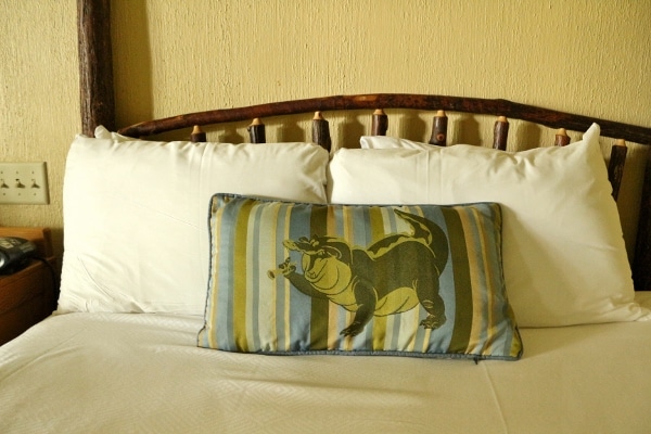 a bedroom accent pillow with an image of an alligator on it