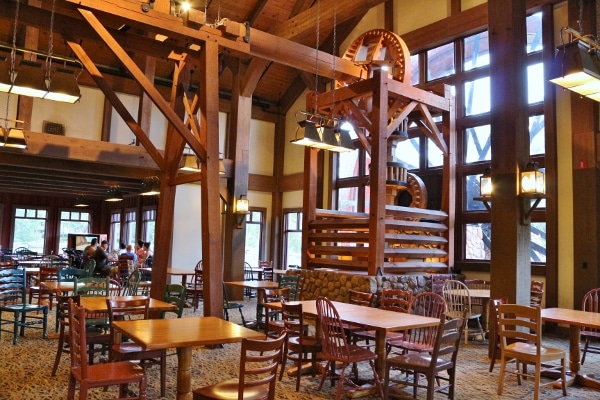 a large dining area with wood tables and chairs and wooden accents