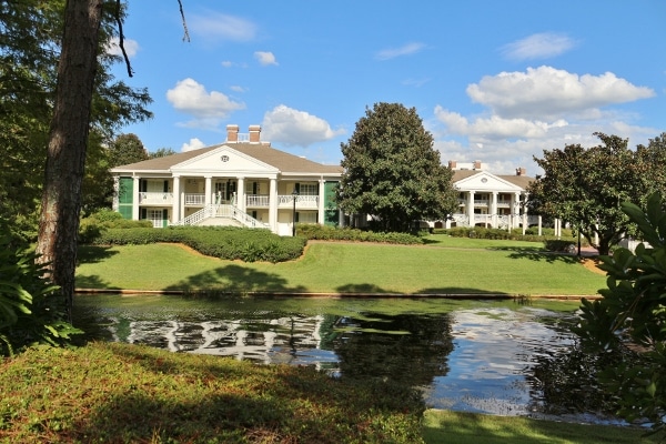 plantation style buildings across a small river