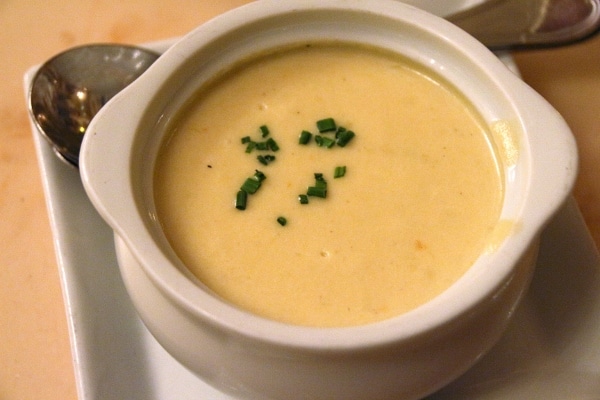 a bowl of creamy soup garnished with chives