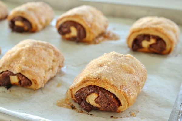 a baking sheet of rugelach spirals with date and chocolate filling