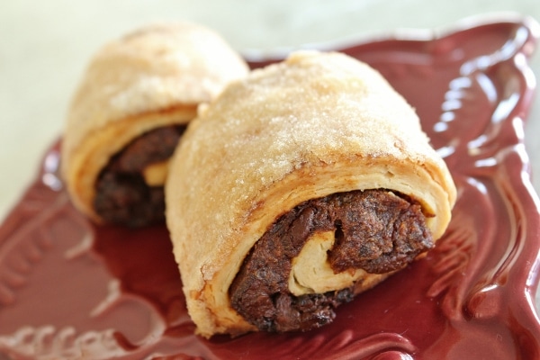 two rugelach pastries served on a red plate