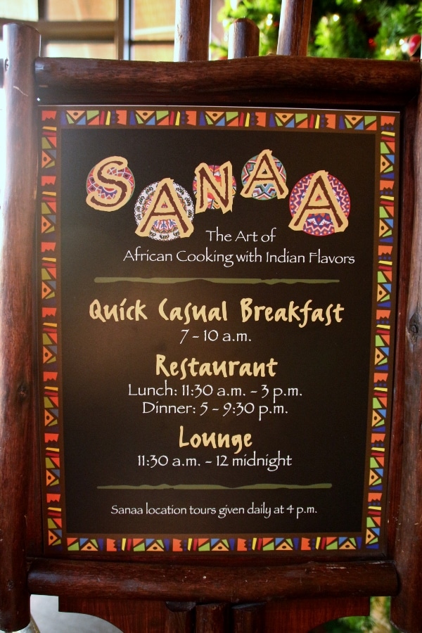 a sign with restaurant hours for Sanaa