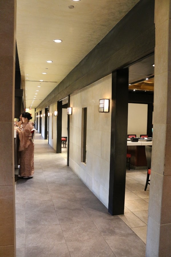 a long hallway with many open doorways