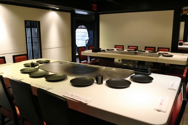 a long hibachi table with a cooking area in the center