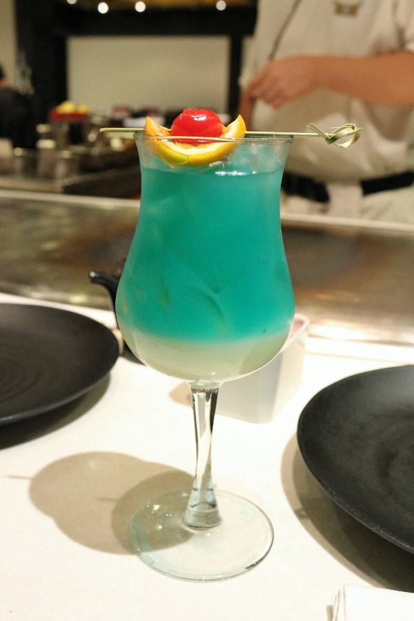 a blue colored cocktail in a glass