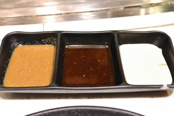 a small dish with three types of sauce in it